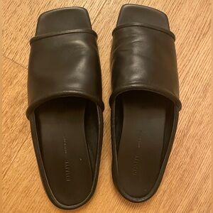 Khaite black leather slide sandals